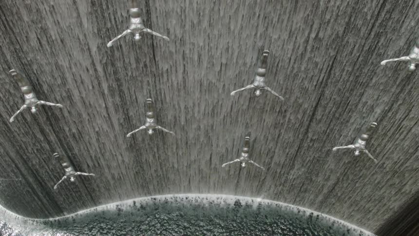 Water cascades over statues in a large fountain
