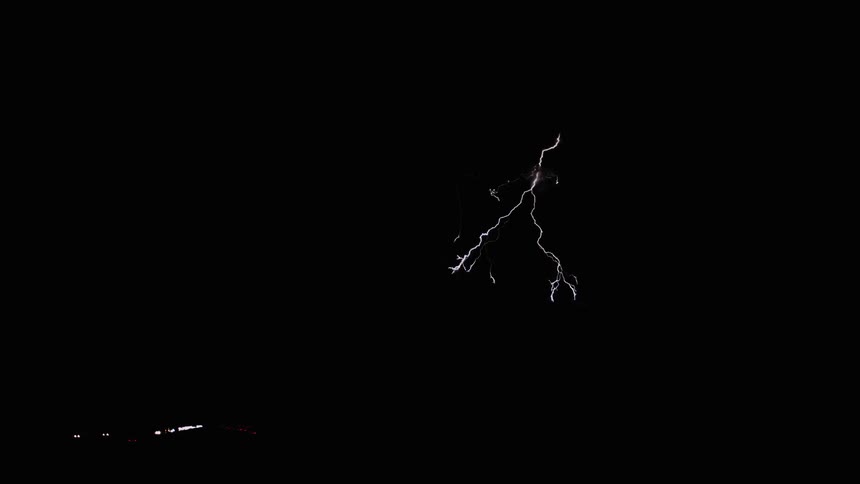 Lightning flashes on the pitch black landscape
