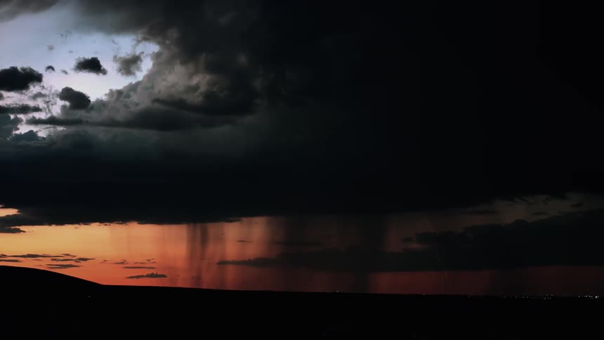 Lightning flashes during a storm at sunset