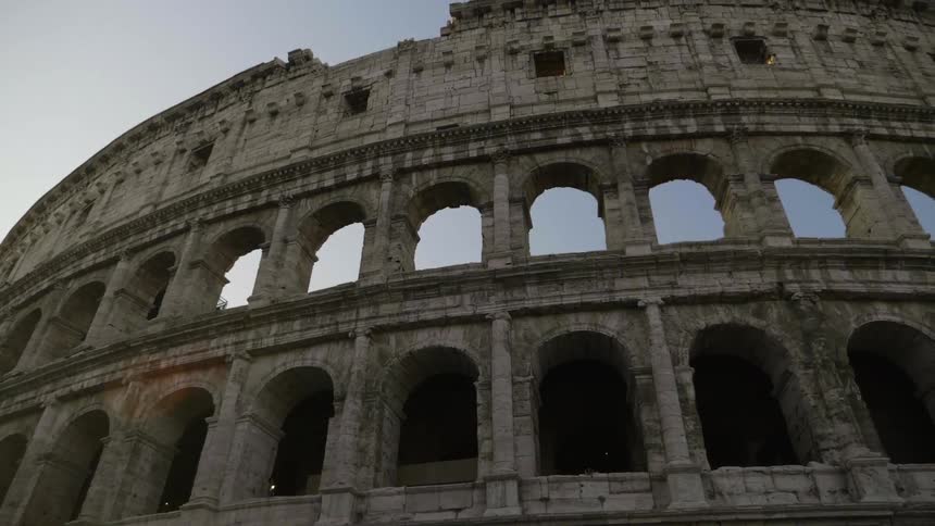 Sky is visible through the arches of the colosseum