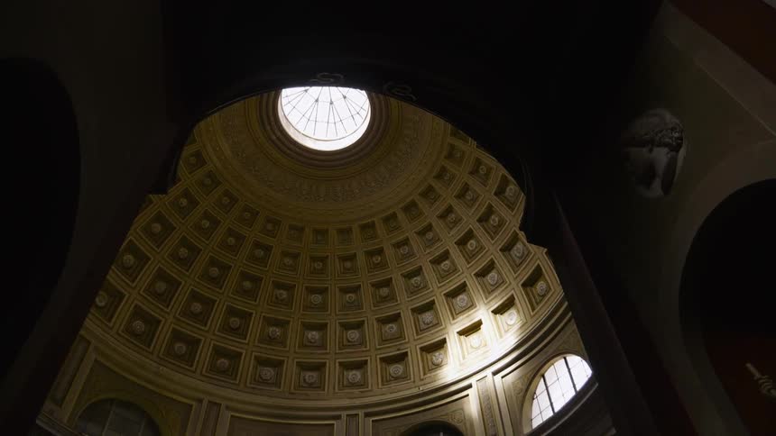 Light shines through the window of a domed ceiling