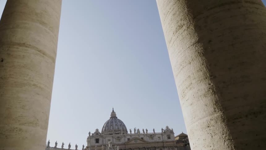 Sunlight shines down on large stone pillars