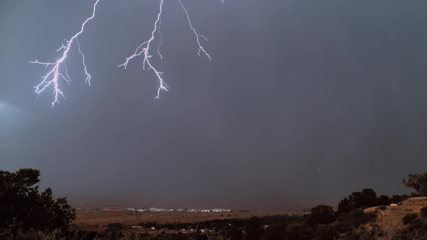 Heavy storm clouds ahead shoot lightning and rain