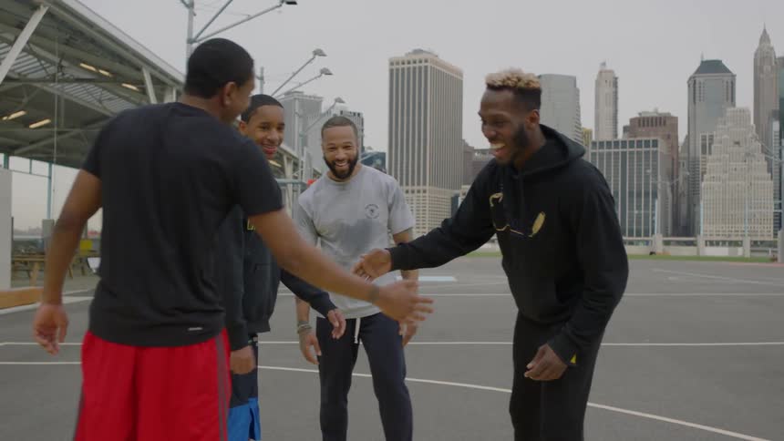 A group of men greet each other on the court