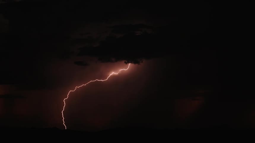 Lightning flashes in the dark night sky