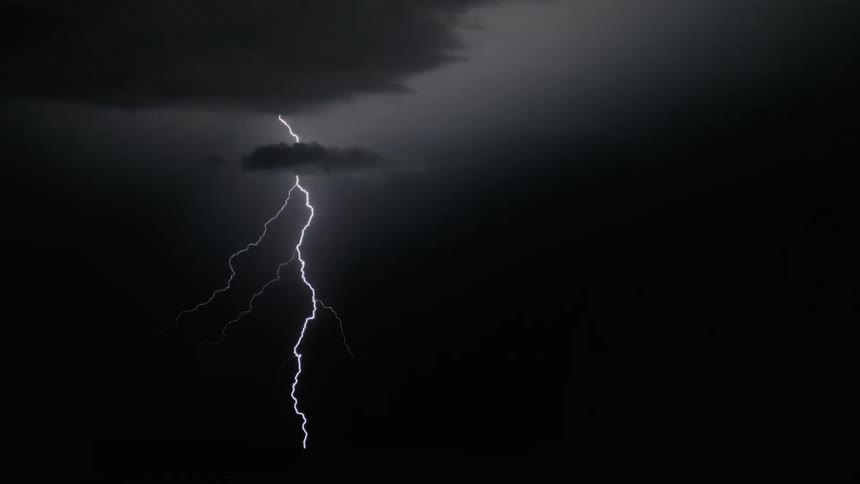 Lightning strikes dance in a dark sky