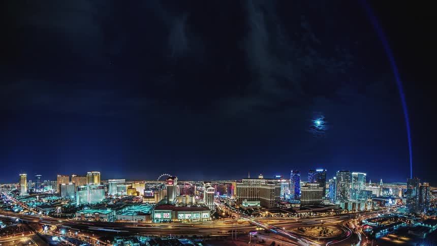 The city is bright at night as vehicles travel on the roads