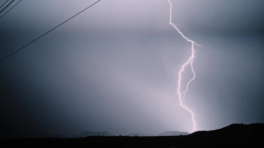 Lightning flashes in the dark night sky