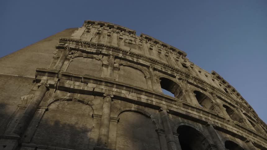 Ancient roman ruins are standing against a clear blue sky