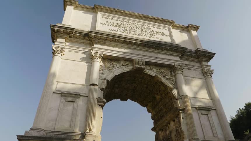 A stone archway is shown on a sunny day