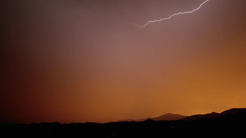 Lightning lights up the sky at sunset