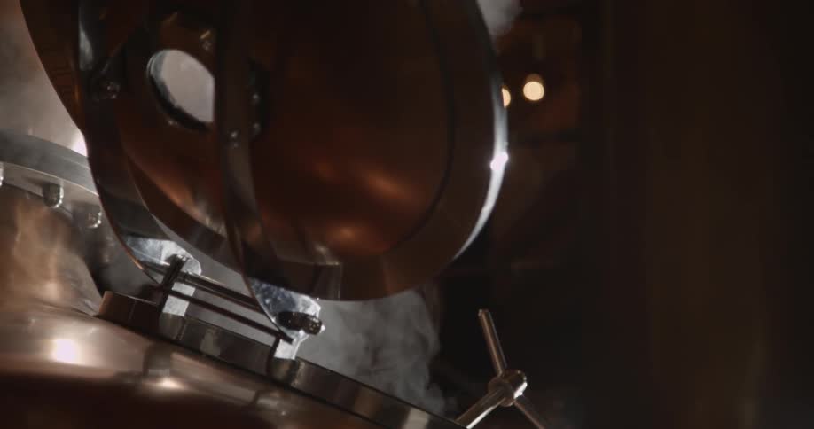 Steam slowly rises from the metal machine