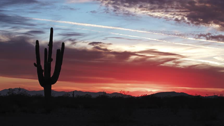 Clouds float over the desert at sunset