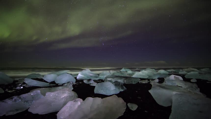 The shore is lined with blocks of ice at night