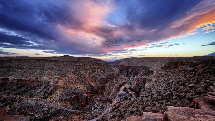 The large cavern has  heavy clouds move above