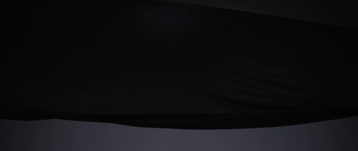 Long fabric blows in the wind in a dark area