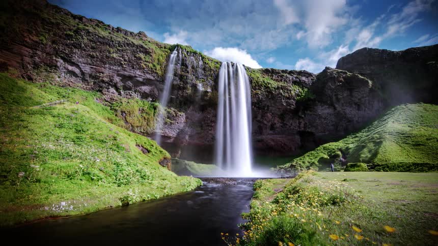 The waterfall is spraying mist all over