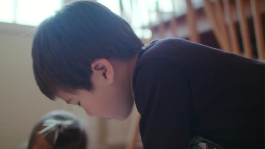 Children are on the floor coloring