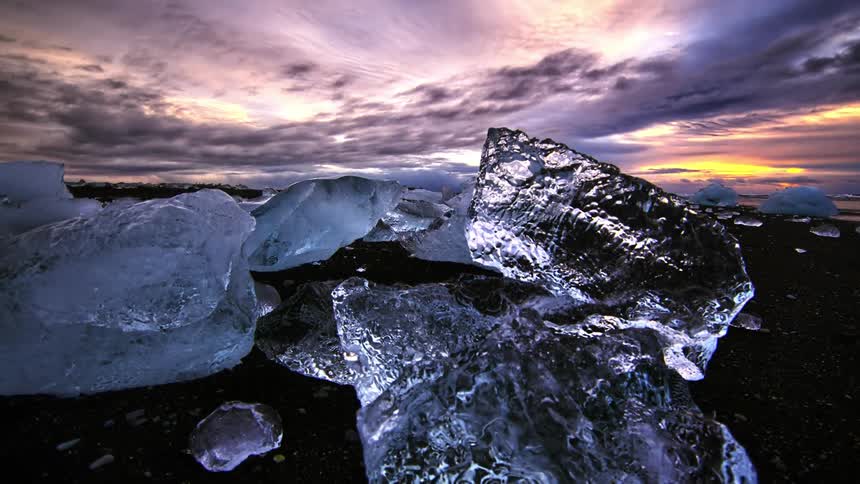 Large chunks of clear ice on a rocky beach