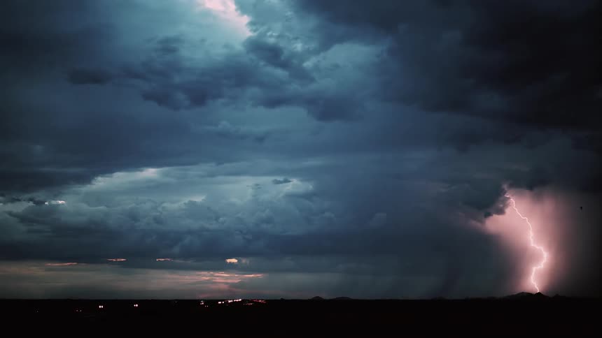 Lightning flashes during a storm at sunset