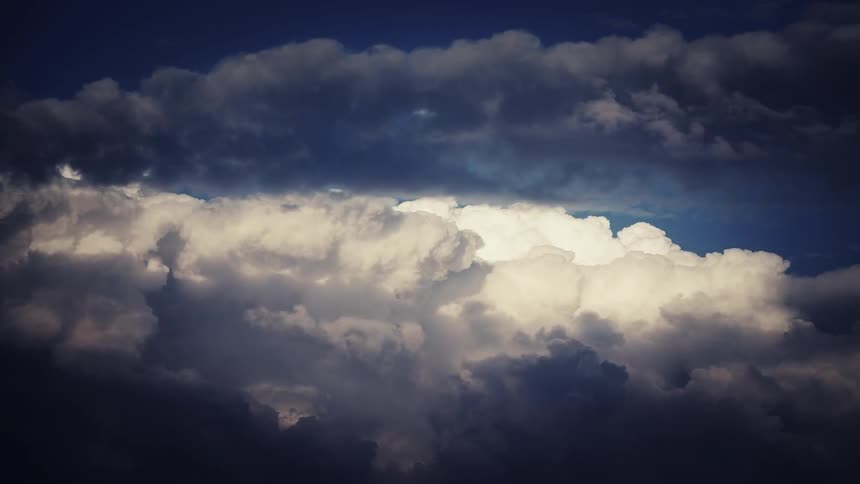 Clouds pass in the blue sky