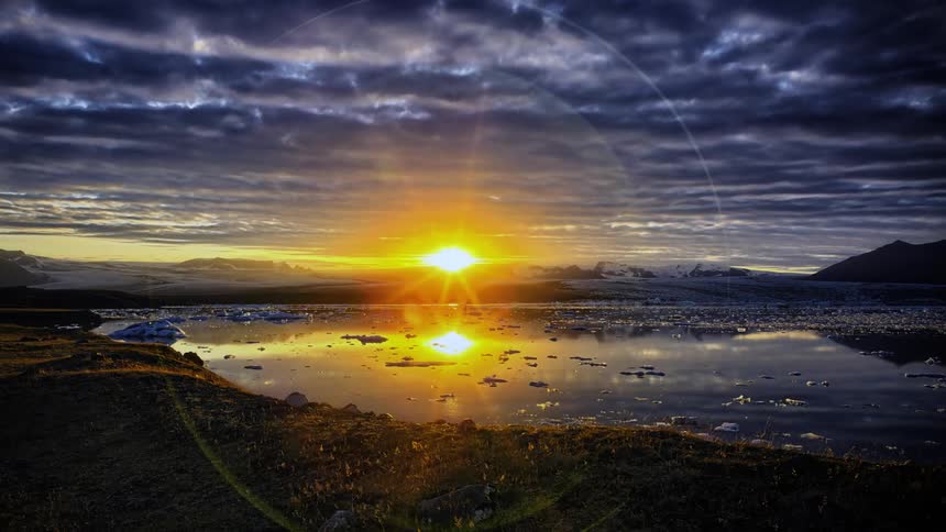 The sun slowly rises over the horizon