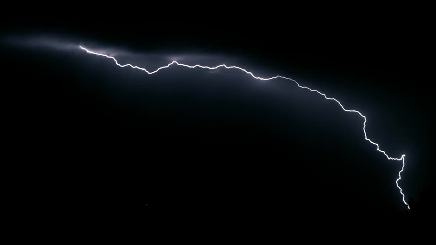 Lightning bolts flash across a black night sky
