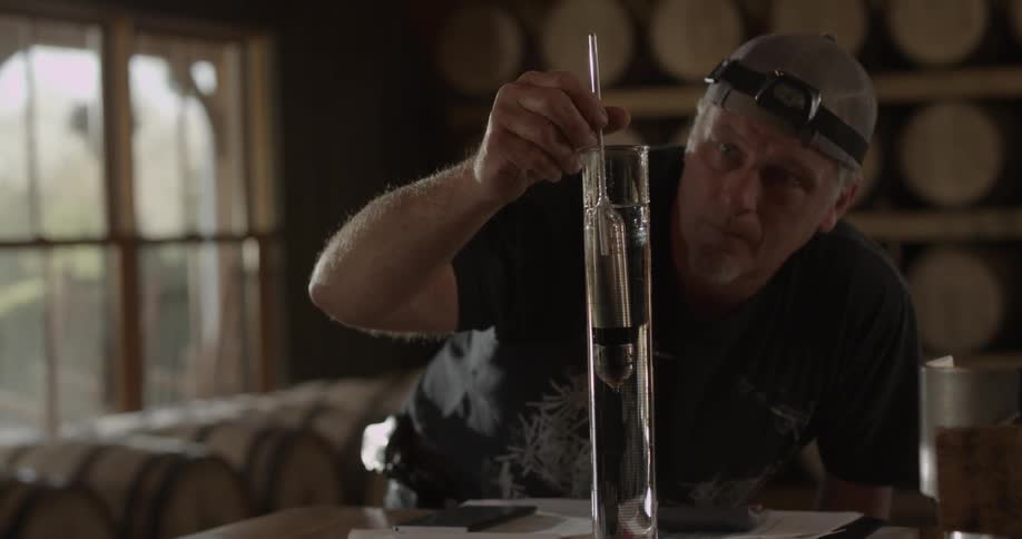 A man is measuring liquid in a vial