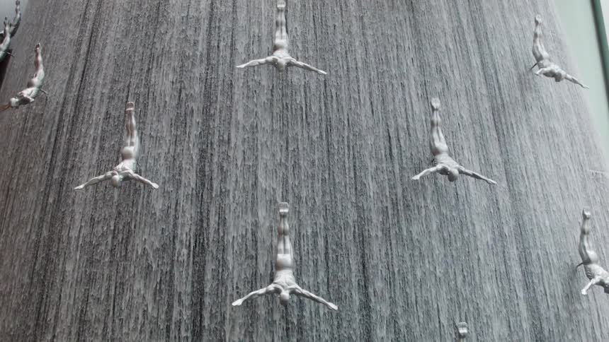 Water cascades over statues in a fountain