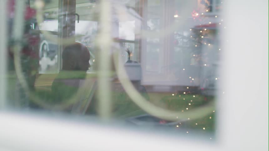 A family sits in a restaurant at christmastime