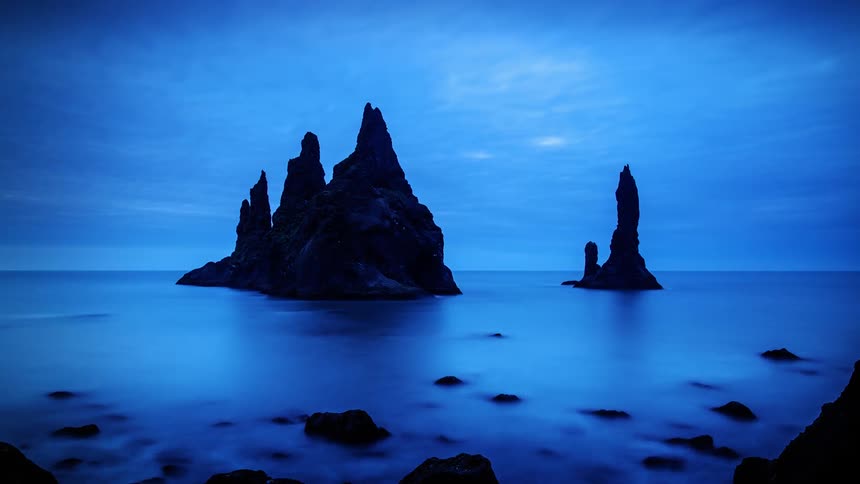 The water has large rock formations ahead