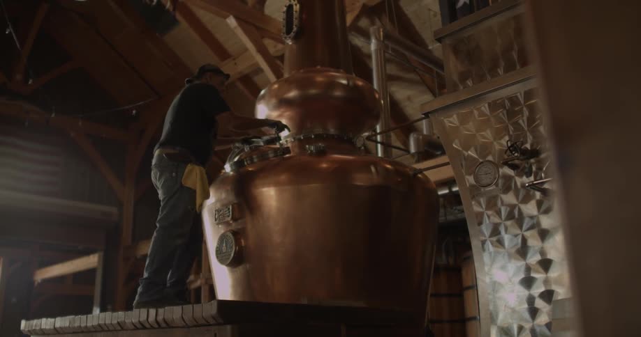 Man unscrews a small door on a kettle