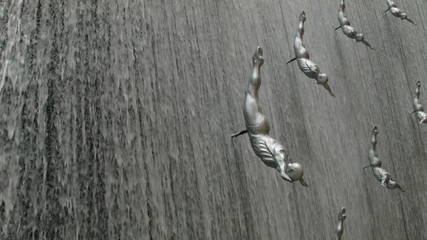 People are diving over a waterfall