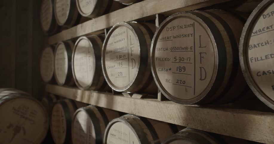 Barrels are lined on these wooden shelves