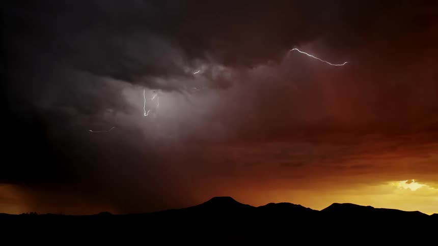 Lightning flashes and moves within the body of storm at dawn