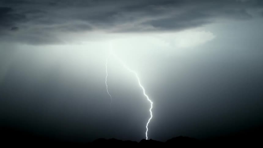 Lightning flashes in the dark night sky