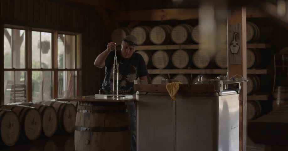 A man inspects a cylinder of liquid