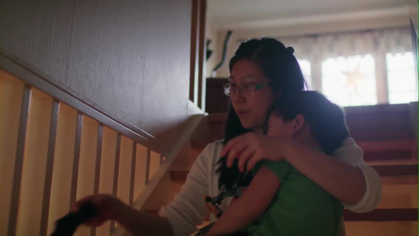 Woman takes socks off her fussy son
