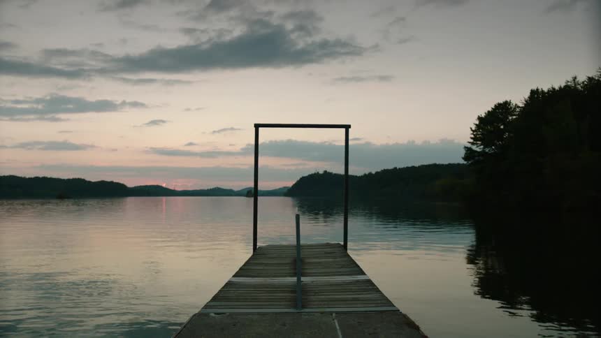 Empty pier on some water at sunset
