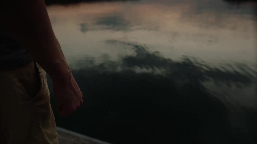 Man standing near some calm waters