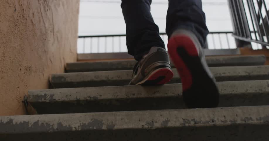 Person walking up a flight of outside stairs