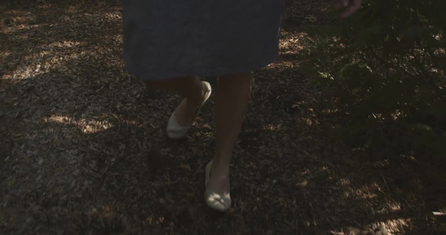 Woman walking down a shaded field