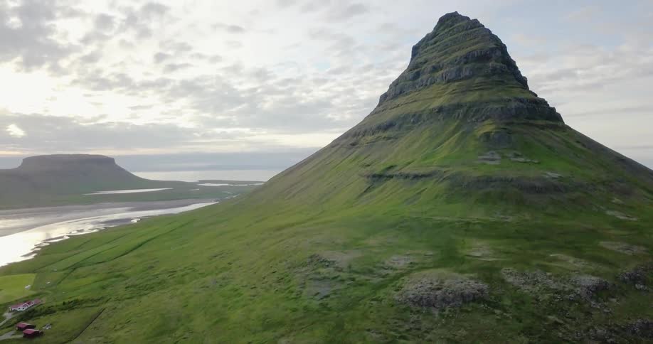 A mountain peak stands on an island in the ocean