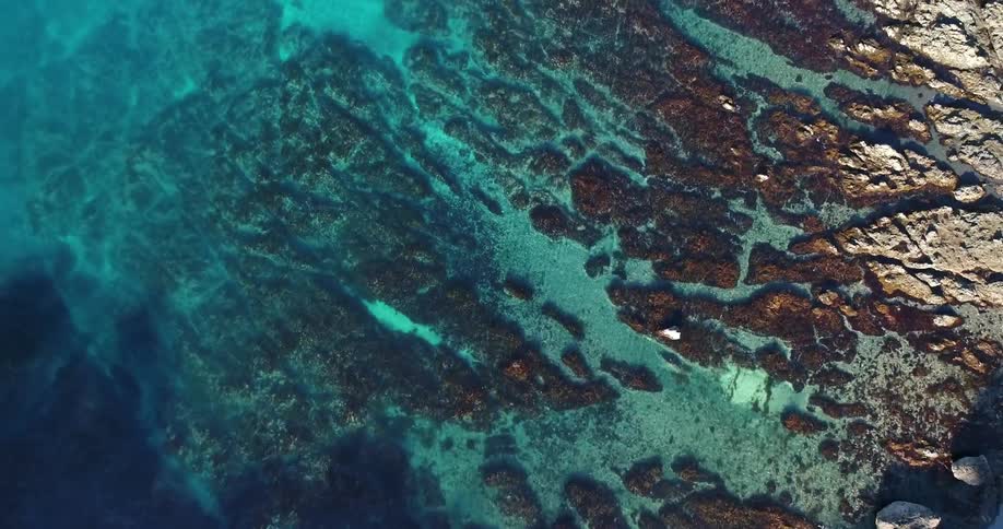Aerial view of shallow water with a rocky bottom