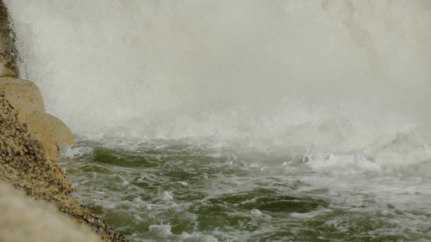 Water churns and splashes in a waterfall