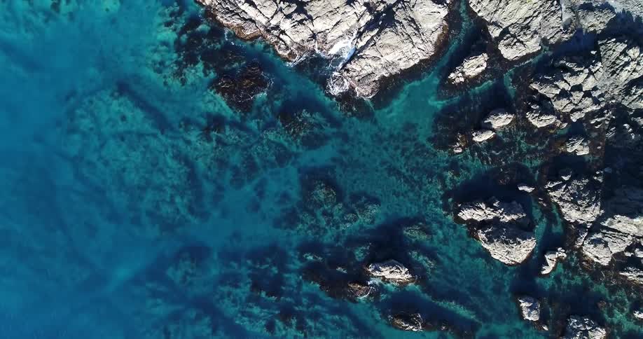Aerial view of shallow water with a rocky bottom