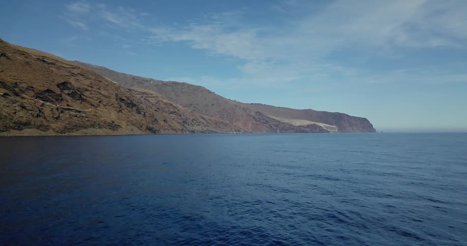 Large body of water with a hilly shoreline