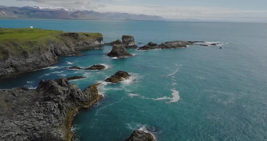 A coastal landscape is shown on a sunny day