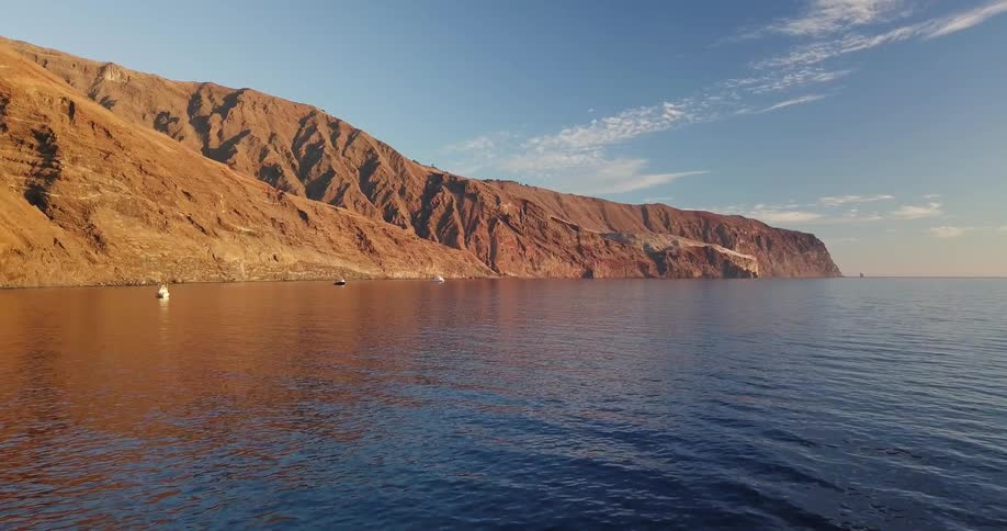 Flowing body of water and hilly shore