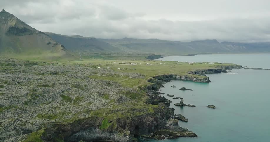 A coastal landscape is shown on a cloudy day